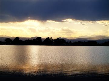 A large body of water at sunset