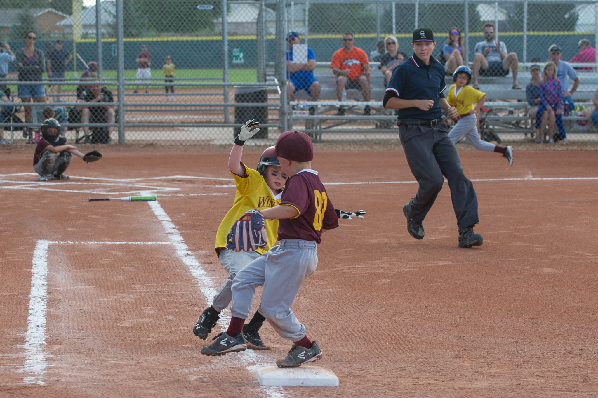 Children playing baseball at a baseball field