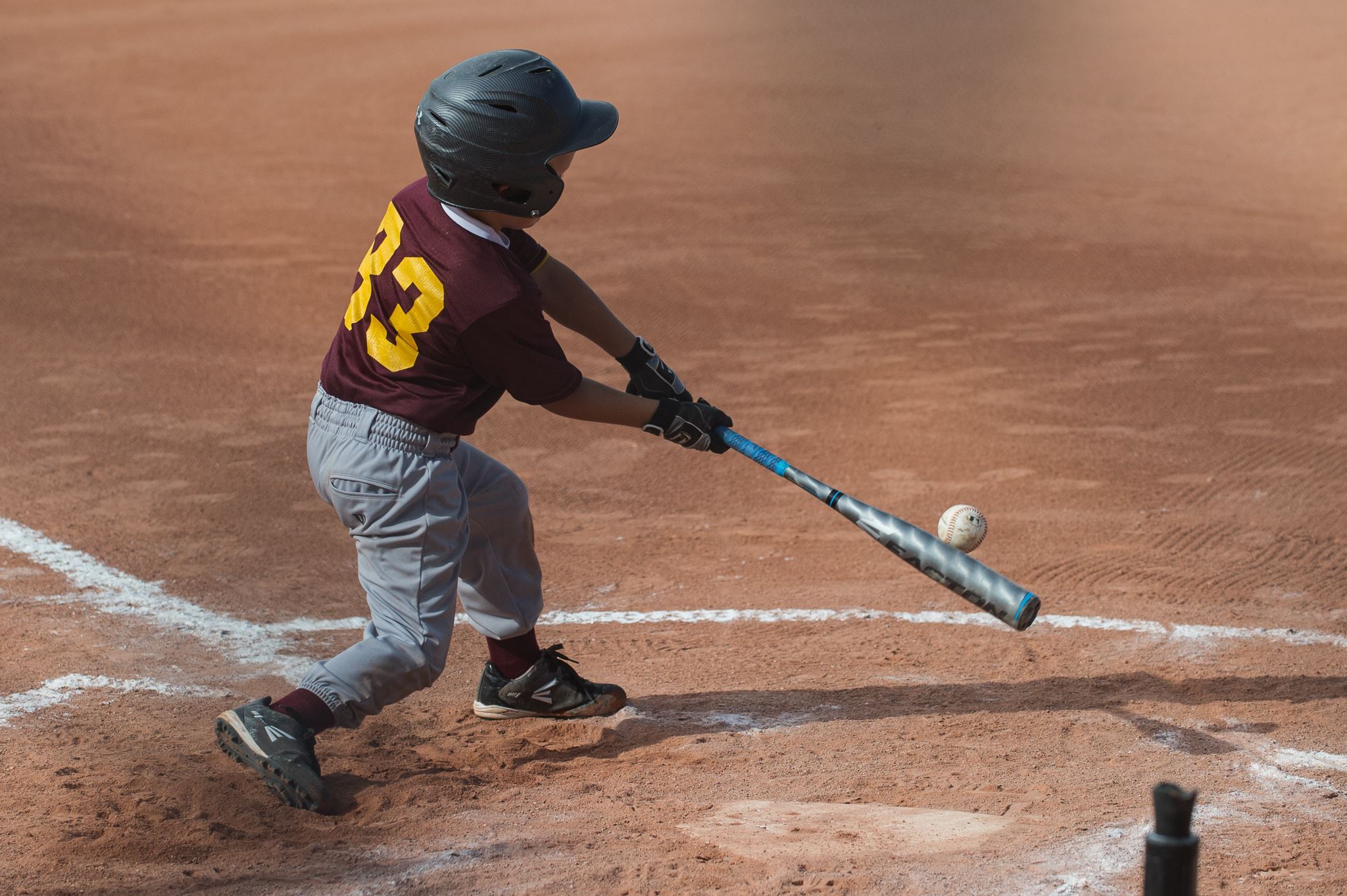 Boy Swings Bat at Ball
