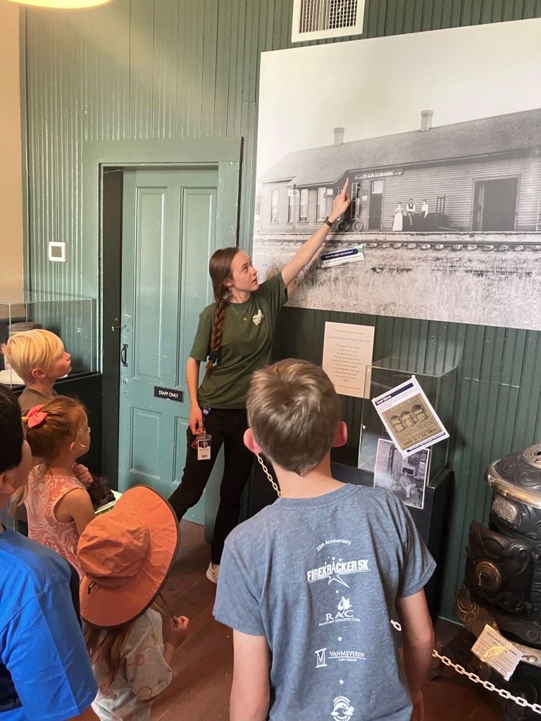 Group of children being lead on a tour of the depot museum.